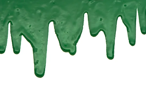 Green paint pouring on white background — Stock Photo, Image