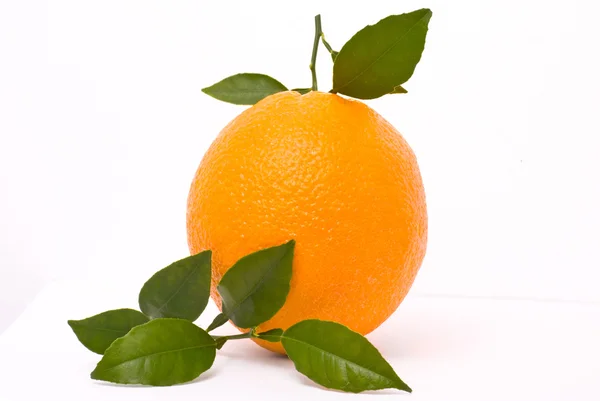 Спелый апельсин с листьями — стоковое фото