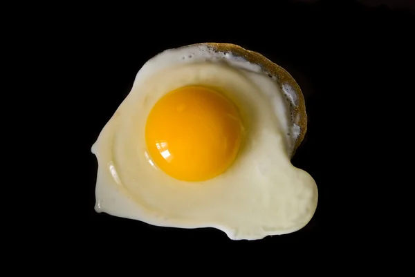 Жареные яйца на черном — стоковое фото