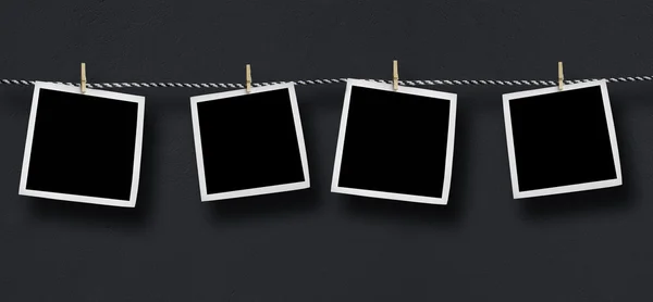 Blank photos hanging on a clothesline — Stock Photo, Image