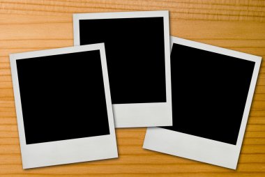 Polaroid frames on wood background clipart