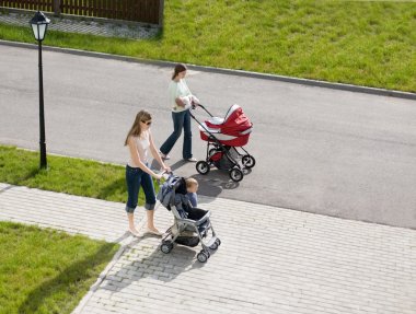 Two mammies walking with babies clipart