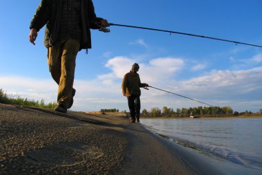 2 Fisherman fishes on a shallow clipart