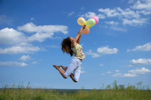 Femme heureuse volant avec des ballons Photos De Stock Libres De Droits