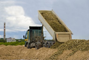 Truck unloading gravel clipart