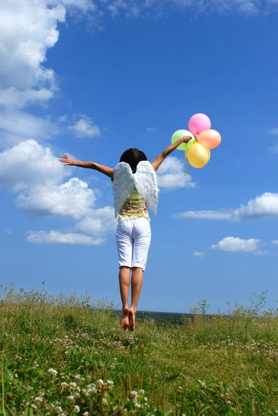 Woman flying with balloons — Stock Photo, Image