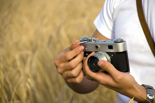 stock image Young man holding film camera