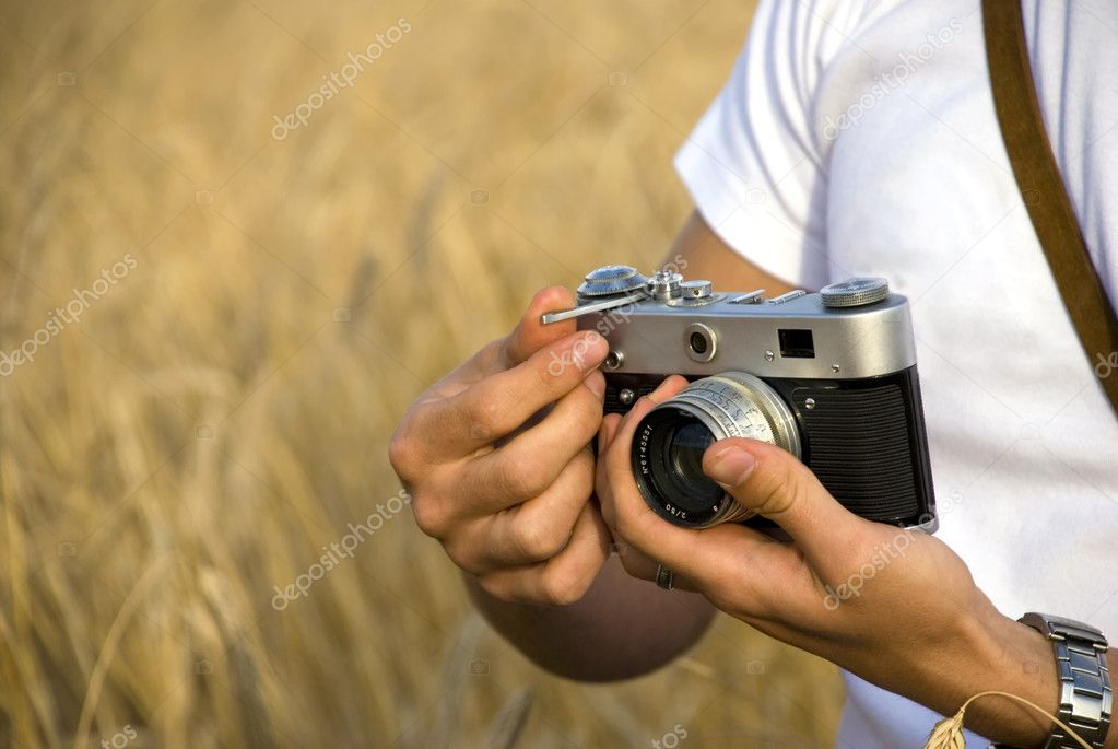 Young man holding film camera