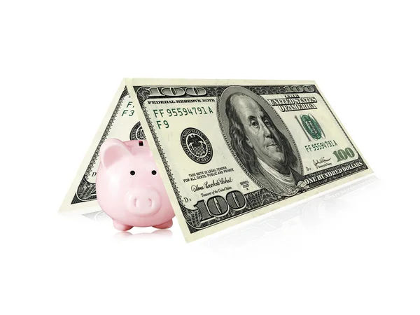 Piggy bank under banknotes — Stock Photo, Image