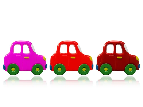Trzy kolorowe zabawki samochody — Zdjęcie stockowe