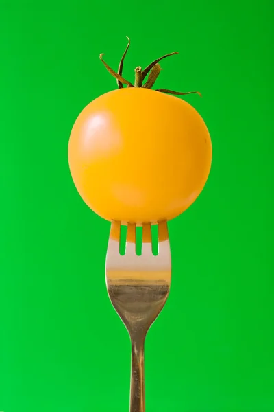 Fork with yellow tomato — Stock Photo, Image