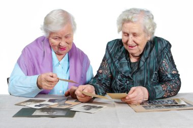 Two grandmothers with old photos. clipart