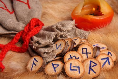 Runes with pouch and candle close-up