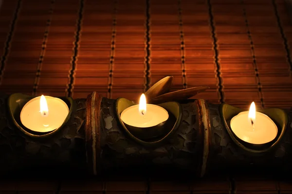 Candles on bamboo rug — Stock Photo, Image