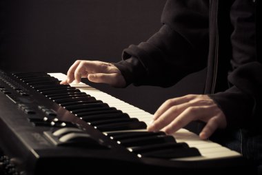 Beautiful man's hands on the keys clipart
