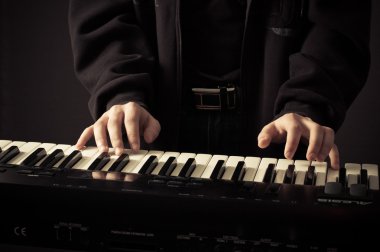 Beautiful man's hands on the keys clipart