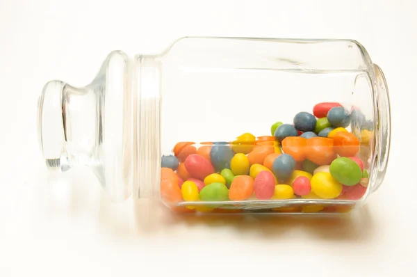 stock image A glass jar with colored candies
