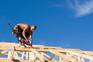 Carpenter Using Nail Gun clipart