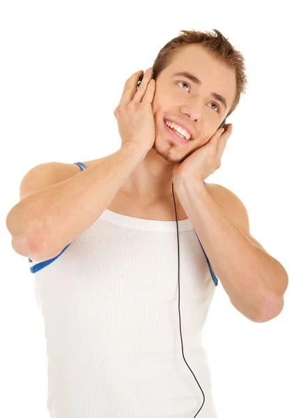 Smiling handsome man is listening music — Stock Photo, Image