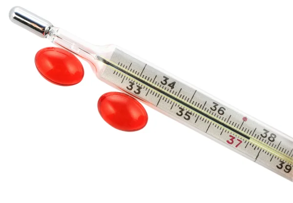 Thermometer with red capsules — Stock Photo, Image