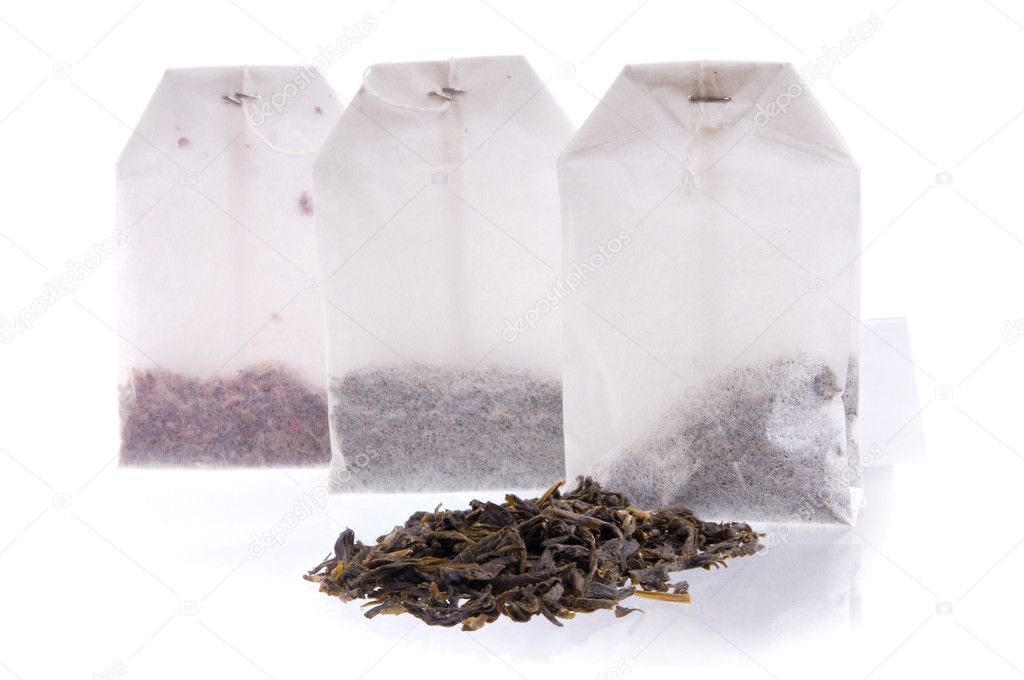 Three teabag and heap of black tea