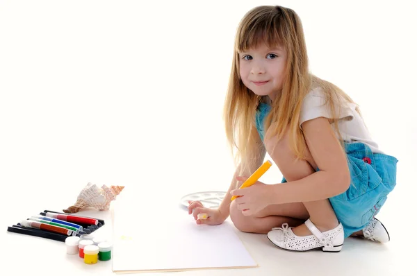 Nice blonde girl is painting — Stock Photo, Image