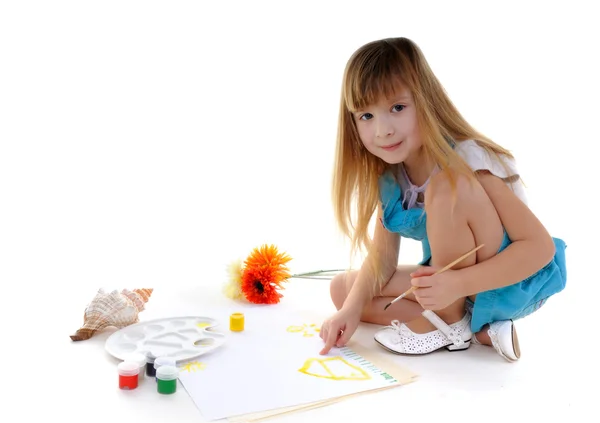 Nice blonde girl is painting — Stock Photo, Image