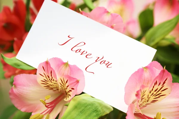Card in flowers with love words — Stock Photo, Image