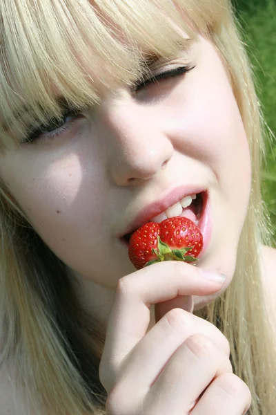 Girl eating berry — Stock Photo, Image