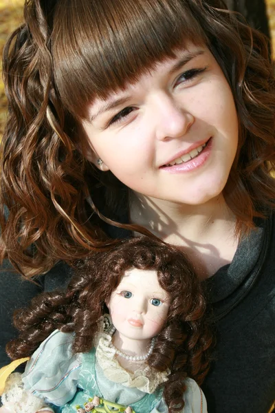 Beautiful girl with doll — Stock Photo, Image
