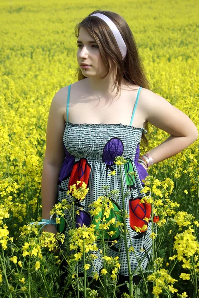 Young girl in canola field — Stock Photo, Image