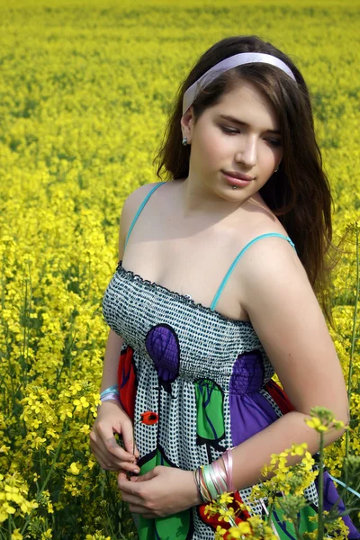 Young girl in canola field — Stock Photo, Image