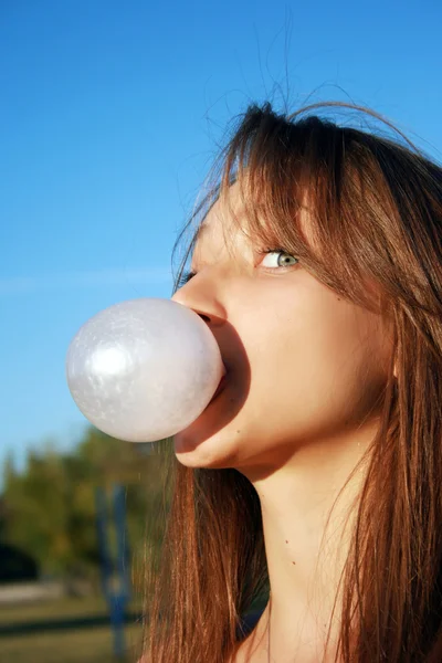 Pretty young girl blowing bubble gum — Stock Photo, Image