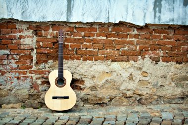 Guitar on old wall clipart