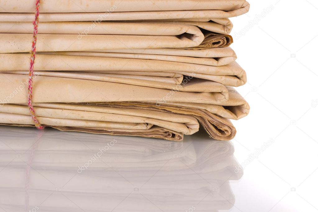 Newspaper stack on white background