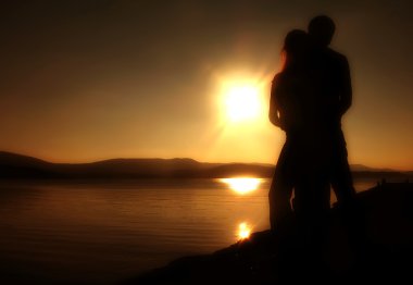 Couple on the beach at sunset clipart