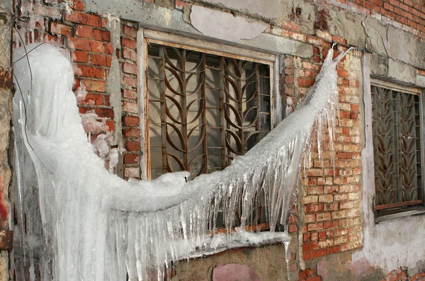 stock image Big icicle and window