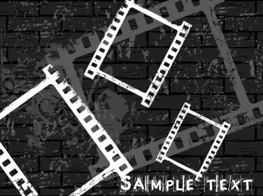 Empty film stripe on grunge wall clipart