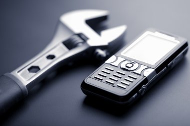 Mobile phone and wrench clipart