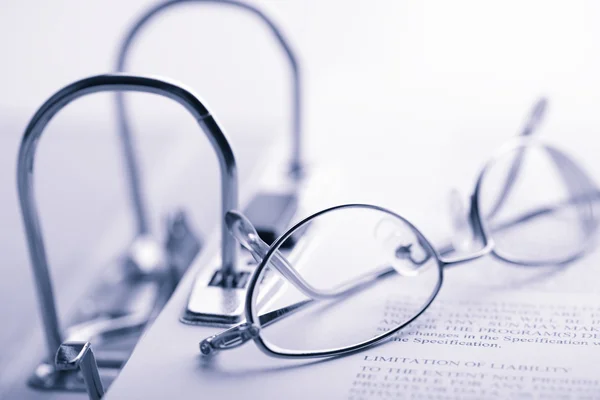 stock image Open binder and glasses toned blue