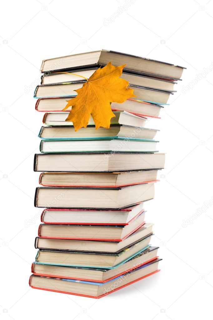 Pile of books and autumn leaf isolated