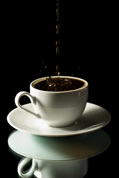Coffee splashing into white cup — Stock Photo, Image