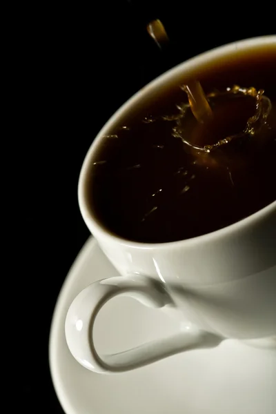 Coffee splashing into white cup — Stock Photo, Image