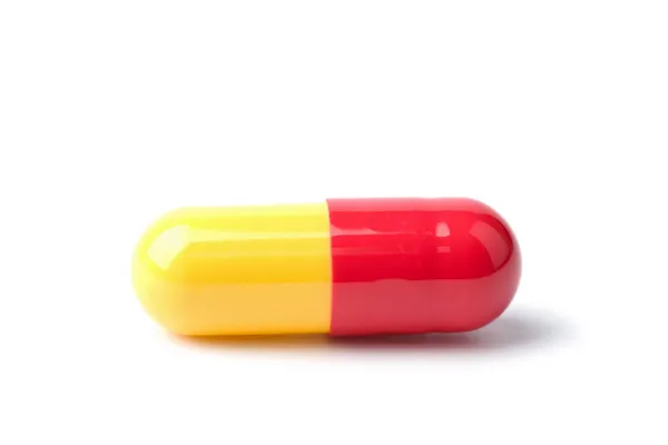Macro of red and yellow capsule pill — Stock Photo, Image