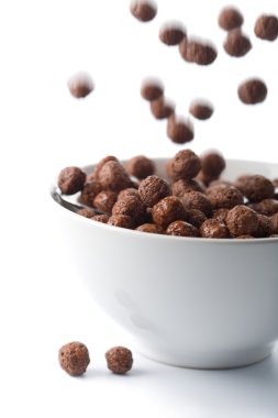 Chocolate balls falling into bowl