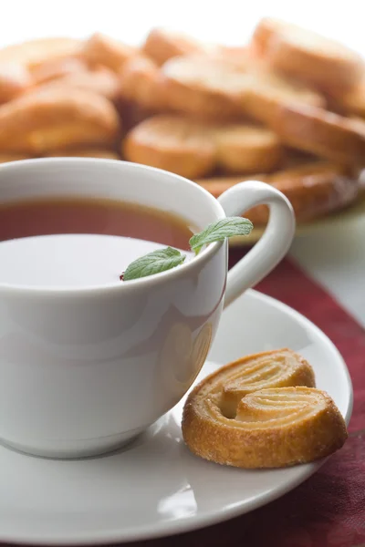 Cup of tea and cookies isolated — Stock Photo, Image