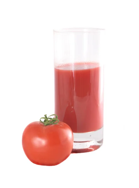 Glass with juice and a tomato — Stock Photo, Image