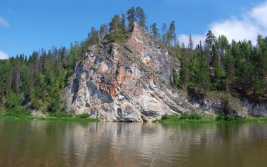 Beautiful rock on coast of the river clipart