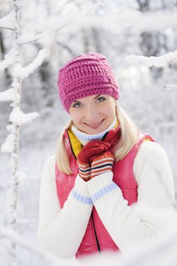 Frozen beautiful woman in winter clothing outdoors clipart