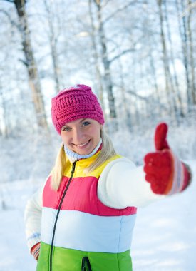 Frozen beautiful woman in winter clothing outdoors clipart